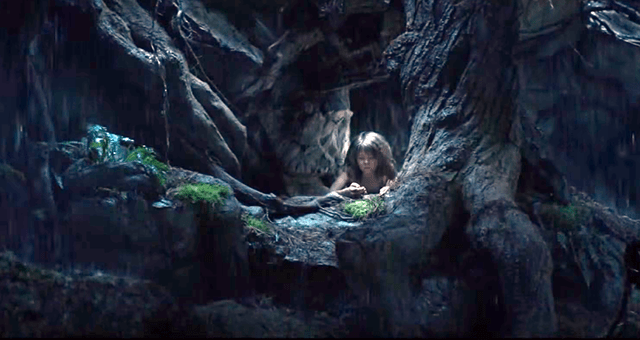 Disney's Pete's Dragon Pete in hollow of tree