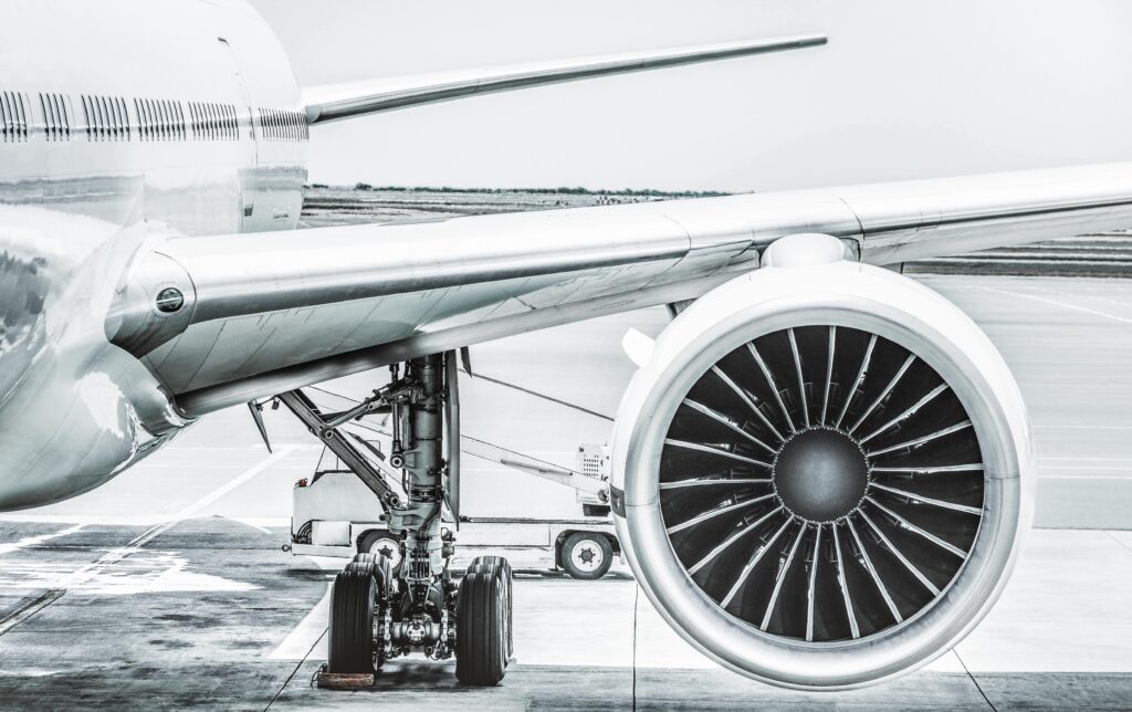 Detail of airplane engine wing at terminal gate before takeoff -